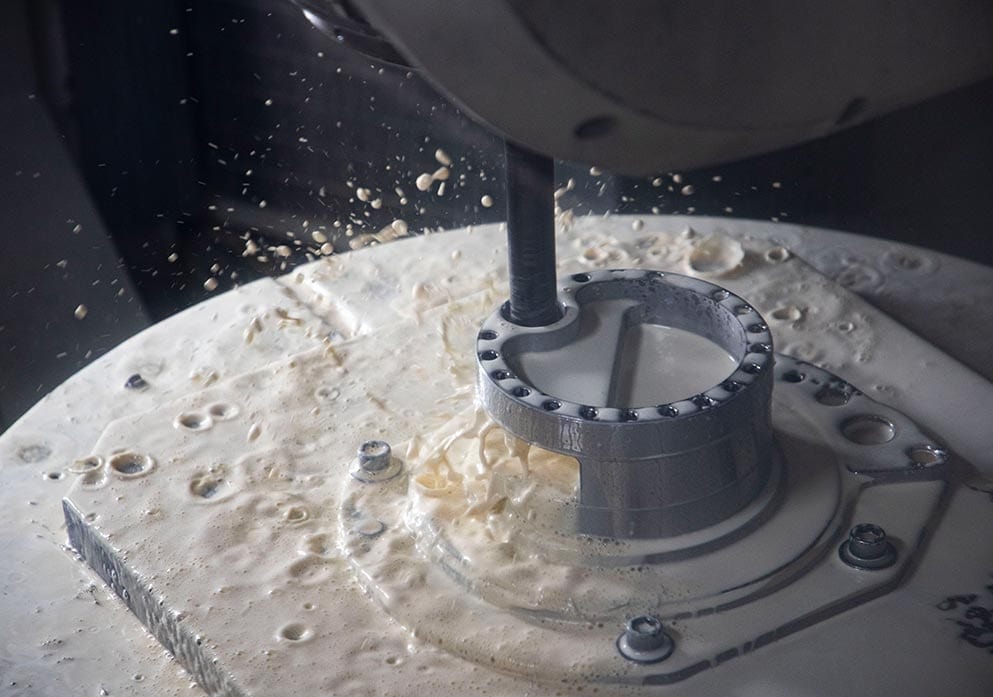 A face mill machining a cast iron component