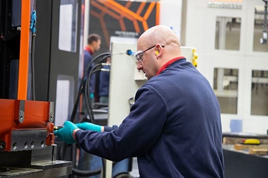 A JHE machinist at the controls of a horizontal machining centre